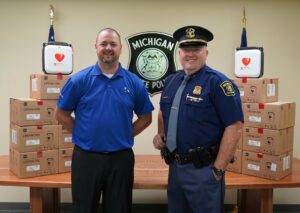 Kalamazoo Mortgage Founding Branch Manager Brian Methner and Michigan State Police Paw Paw Post Commander Scott Ernstes